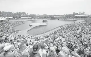  ?? RICHARD HEATHCOTE/GETTY IMAGES ?? A large crowd watches Tiger Woods on the green of the par-3 17th hole during third round play on the Stadium Course.