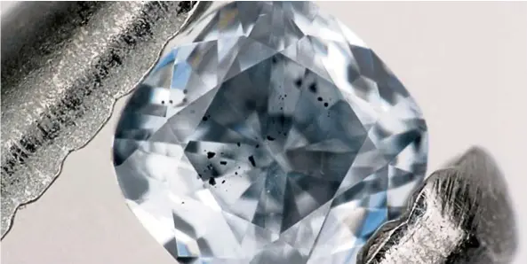  ?? —TNS ?? A blue, boron-bearing diamond with dark inclusions of a mineral called ferroperic­lase, which were examined as part of this study. This gem weighs 0.03 carats.