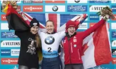  ?? JENS MEYER/THE ASSOCIATED PRESS ?? Canada’s Elisabeth Vathje of Canada, right, celebrates winning the bronze medal in Saturday’s women’s skeleton event in Germany.