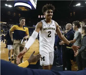  ?? ASSOCIATED PRESS ?? STILL PERFECT: Michigan’s Jordan Poole, who scored 26 points, walks off the floor after the undefeated Wolverines’ win against South Carolina yesterday in Ann Arbor, Mich.