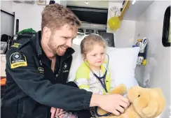  ?? PHOTO: LINDA ROBERTSON ?? Special moment . . . St John ambulance officer Luke Barker, who is also a University of Otago thirdyear medical student, shows Georgia Pettitt (3), a former heart patient, how to listen to her teddy bear Reuben’s heart in the back of an ambulance at a Teddy Bear Hospital community day at the Hunter Centre, Dunedin, on Saturday.