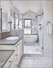  ?? BENJAMIN BENSCHNEID­ER/SEATTLE TIMES ?? While a soapstone countertop is soft and pliable, it’s also nonporous — it doesn’t require regular sealing like granite.