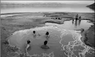  ?? ODED BALITY / ASSOCIATED PRESS ?? People take a dip in a water pool on the Dead Sea shore near Ein Gedi, Israel, on Nov 24.