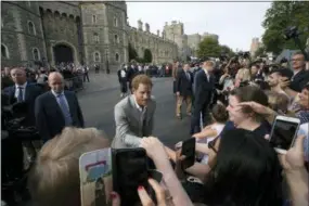 ?? PETER DEJONG — THE ASSOCIATED PRESS ?? Britain’s Prince Harry and Prince William greet well-wishers outside Windsor castle, in Windsor, England, Friday, ahead of Prince Harry’s wedding to Meghan Markle on Saturday.