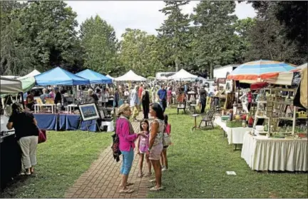  ?? CONTRIBUTE­D PHOTOS ?? Visitors mingle during last year’s antiques fair in Madison. The 46th annual fair, hosted by the Madison Historical Society, draws new and returning visitors for a day of treasure hunter, expert appraisals, booth chats by exhibitors and a chance to see...