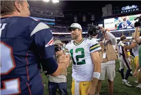  ?? DAVID BUTLER II/USA TODAY SPORTS ?? The Patriots’ Tom Brady and the Packers’ Aaron Rodgers, right, will meet in a heavyweigh­t showdown Sunday.
