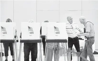  ?? MATT BUTTON /BALTIMORE SUN MEDIA GROUP ?? Election Judge William Bowlin directs voters to open stations during early voting at the McFaul Activity Center in Bel Air on Thursday morning. Early voting officially began Thursday in Maryland.