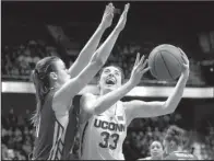  ?? AP/ JESSICA HILL ?? Connecticu­t guard Katie Lou Samuelson ( right) set an American Athletic Conference single- game tournament scoring record with 40 points in Monday night’s 100- 44 victory over South Florida.