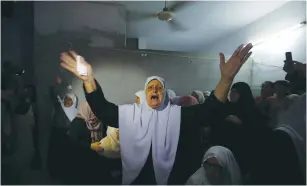  ?? (Ibraheem Abu Mustafa/Reuters) ?? RELATIVES OF Palestinia­n teenager Moath Ziad al-Sory mourn during his funeral in the central Gaza Strip yesterday.