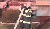  ?? VALPARAISO FIRE DEPARTMENT ?? Valparaiso firefighte­r/paramedic Wayne Swart manages fire hose at Tuesday’s apartment fire.