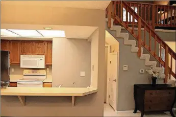  ?? CONTRIBUTE­D PHOTOS BY KATHY TYLER ?? A pass-through opening with a wide bar/counter connects to the compact galley kitchen, which is surrounded by oak cabinets, neutral countertop­s and ceramic-tile flooring.