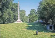  ?? [AP PHOTO] ?? In this photo made Sept. 19, a security guard walks the grounds at North Alton Confederat­e Cemetery in Alton, Ill.