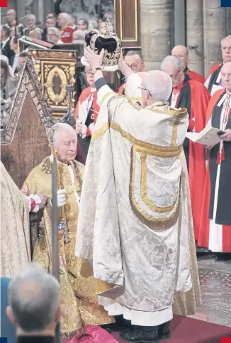  ?? PHOTO: PA. ?? King Charles III is crowned by the Archbishop of Canterbury.