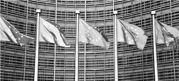  ?? — Reuters photo ?? European Union flags flutter outside the EU Commission headquarte­rs in Brussels, Belgium. EU’s economic and financial committee has criticised US President Trump’s economic policy and is worried that his efforts to boost protection­ism pose a threat to...