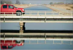  ??  ?? RECORDER PHOTO BY CHIEKO HARA The bridge on Avenue 96 spanning the Friant-kern Canal west of Terra Bella, where a recent survey by the Friant Water Authority discovered the ground beneath the canal had dropped five inches in five months due to...