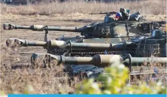  ??  ?? PAJU: South Korean army’s K-55 self-propelled howitzers take a position at a military training field in the border city of Paju yesterday. —AFP