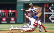  ?? CHRIS SZAGOLA — THE ASSOCIATED PRESS ?? Los Angeles Dodgers shortstop Trea Turner, top, throws to first after getting an out against Philadelph­ia Phillies’ Alec Bohm, bottomt, during the first inning of a baseball game on Sunday.