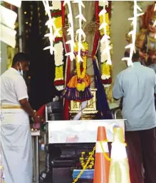  ??  ?? Muted affair: Devotees praying at the Sri Maha Mariamman Temple in Queen Street.