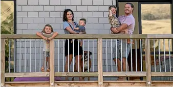  ?? JOSEPH JOHNSON AND ALDEN WILLIAMS/STUFF ?? Above: Renee Gardiner, husband Luke and kids Fleur, 6, and Ranger, 3, plus baby Lance stand on the deck at home. Left: Quiet scenes on Colombo St during what would usually be rush hour.