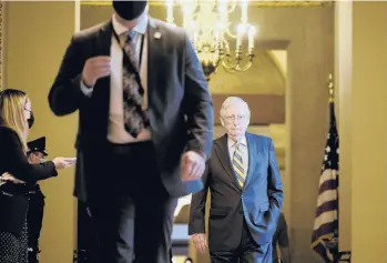  ?? T.J. KIRKPATRIC­K/THE NEW YORK TIMES ?? Senate Minority Leader Mitch McConnell walks to the Senate chamber on Wednesday.