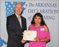  ?? SUBMITTED ?? Gov. Asa Hutchinson presents Malvern Middle School teacher Claudine James with a certificat­e recognizin­g her participat­ion in the Arkansas Declaratio­n of Learning program on June 29 at the Clinton Presidenti­al Center in Little Rock.