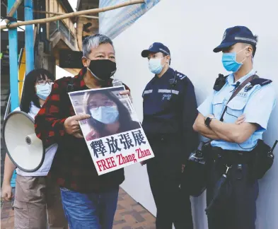  ?? TYRONE SIU / REUTERS ?? Pro-democracy supporters urge for the release of 12 Hong Kong activists arrested as they reportedly sailed to Taiwan for political asylum, as well as journalist Zhang Zhan on the Mainland, outside China's Liaison Office in Hong Kong.