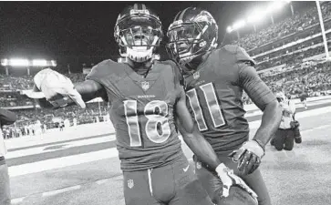  ?? KENNETH K. LAM/BALTIMORE SUN ?? Ravens wide receiver Jeremy Maclin, left, celebrates with teammate Breshad Perriman after scoring a touchdow in a victory over the Dolphins. Maclin caught just 40 passes for 440 yards and three touchdowns last season.