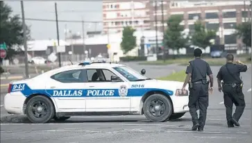  ?? Laura Buckman
AFP/Getty Images ?? DALLAS POLICE close off a street after a shooting. Citizens with the Cop Block campaign film traffic stops and watch officers for potential violations of search laws. The Arlington chapter does so with a Texas f lair.