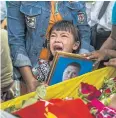  ??  ?? ANGUISH: Shwe Yote Hlwar, 5, holds a portrait of her father, Zwe Htet Soe, 26, who was killed while protesting.