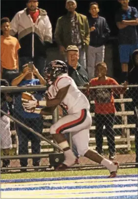  ?? MICHAEL REEVES — FOR DIGITAL FIRST MEDIA ?? Above at left and right, Coatesvill­e’s Dapree Bryant hauls in the game-winning touchdown pass from Ricky Ortega with three seconds left in Friday’s game against Downingtow­n East at Kottmeyer Stadium.