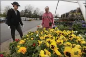  ?? STEVE HELBER — THE ASSOCIATED PRESS ?? Gail Henrickson and her daughter Melissa shop for plants at a local garden center in Richmond, Va.