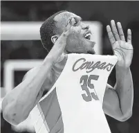  ?? Jamie Squire / Getty Images ?? UH’s Fabian White Jr., who scored seven points off the bench, celebrates the Cougars’ victory over the Scarlet Knights.