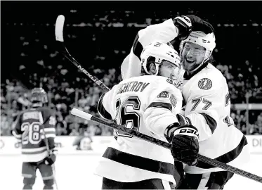  ??  ?? Tampa Bay Lightning right wing Nikita Kucherov, front, and Tampa Bay Lightning defenseman Victor Hedman celebrate a goal by left wing Ondrej Palat against the New York Rangers on Friday in New York.