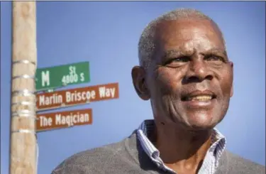  ?? KENT SIEVERS — OMAHA WORLD-HERALD VIA AP, FILE ?? Marlin Briscoe stands in front of a street that was renamed for him in Omaha, Neb. The Pro Football Hall of Fame calls the Omaha, Neb. native the first black quarterbac­k in the modern era of pro football.