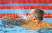  ?? Tom Pennington / Getty Images ?? Caeleb Dressel reacts after competing in the 50meter free heats. The American is favored to win gold in the event.