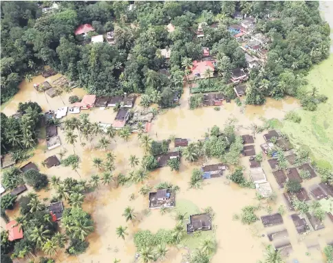  ??  ?? An aerial view shows partially submerged houses at a flooded area in the southern state of Kerala, India.