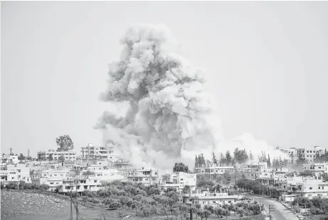  ?? Mohamad Abazeed / AFP / Getty Images ?? Smoke billows after a reported airstrike Saturday on a rebel-held area in the Syrian city of Daraa. One person was killed.