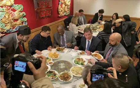 ?? SEAN PHILIP COTTER / BOSTON HERALD ?? MARTY’S MEAL: Mayor Martin Walsh, Inspection­al Services Commission­er Dion Irish and Health Commission­er Marty Martinez eat lunch at Jade Kitchen in Chinatown, seen below left, as part of a tour to promote business in the area. The mayor sought to stike down any coronaviru­s fears as the area sees a drop in customers.
