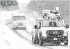  ?? Kin Man Hui / Staff photograph­er ?? CPS Energy trucks rumble down Vance Jackson Road during Winter Storm Uri this February.