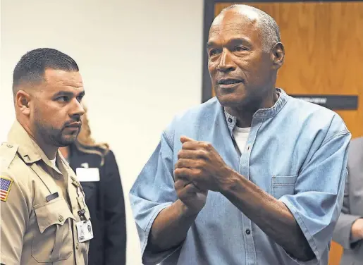  ?? JASON BEAN, RENO GAZETTE- JOURNAL ?? O. J. Simpson reacts Thursday after learning he was granted parole in Nevada. He is due to be released Oct. 1.