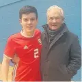  ??  ?? ● Ifan Roberts wearing his Wales kit with his grandfathe­r Gwilym Roberts