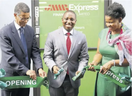  ??  ?? CEO of JMMB Express Finance Elson James (centre) is assisted by JMMB Group Chairman Archibald Campbell (left) and JMMB human resource consultant Diana Burgess for the opening of JMMB Express Finance. The event took place on September 12 at the new facility housing JMMB Express Finance at 86 Ramsaran Street, Chaguanas in Trinidad and Tobago. The new subsidiary is the third arm of JMMB Group in Trinidad and Tobago and is intended to get more people into the formal financial sector.