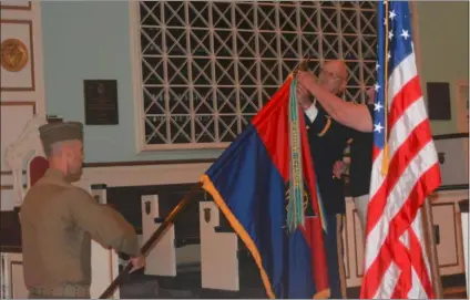  ?? RICHARD ILGENFRITZ - MEDIANEWS GROUP ?? Kenneth Seitz, chief of staff at Valley Forge Military Academy and Kathleen Powers, past president of the 83rd Infantry Division Associatio­n, place a battle streamer on the unit flag in recognitio­n of the division’s service during the Battle of Vittorio Veneto in Italy that occurred in 1918 shortly before the end of World War I.