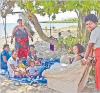  ?? Picture: REINAL CHAND ?? Women and children rest by the beachside at Naqiroso settlement in Lautoka.