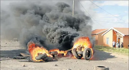  ?? Picture: MALIBONGWE DAYIMANI ?? UP IN SMOKE: The Mdantsane Access road was closed between Sunnyside intersecti­on and Woolwash intersecti­on because parallel to that 2km stretch of road, clashes between angry Egoli residents and riot police continued