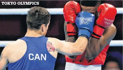  ?? UESLEI MARCELINO • REUTERS ?? Canada’s Wyatt Sanford lands a punch square on the face of Merven Clair of Mauritius during preliminar­y action in the men’s welterweig­ht class at the Tokyo Olympics on Saturday. Sanford, of Kennetcook, lost 5-0 to Clair.