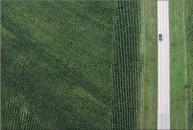  ??  ?? A car drives past a farm in June of 2007 in Hutto, Texas. After President Donald Trump announced plans to impose tariffs on products the Chinese government responded Friday, March 23, 2018, with a threat to add an equal 25 percent charge on U.S....