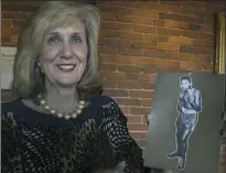  ?? Darrell Sapp/Post-Gazette ?? Denise Allen holds a photo of Muhammad Ali at the age of 12 years old, when he was known as Cassius Clay. The photo belonged to Fred Lenn.