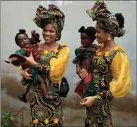  ?? ?? Oladapo Taiwo, left, and Oladapo Kehinde, 21, hold the relative’s twins during the twin festival in Igbo-ora South, Nigeria, which celebrates the town’s high number of twins and multiple births