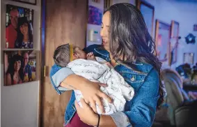  ?? ROBERTO E. ROSALES/JOURNAL ?? Jocelyn Lobato holds her baby daughter, Athens. Lobato sees the expanded child tax credit that was part of the American Rescue Plan as a lifeline for her young family.